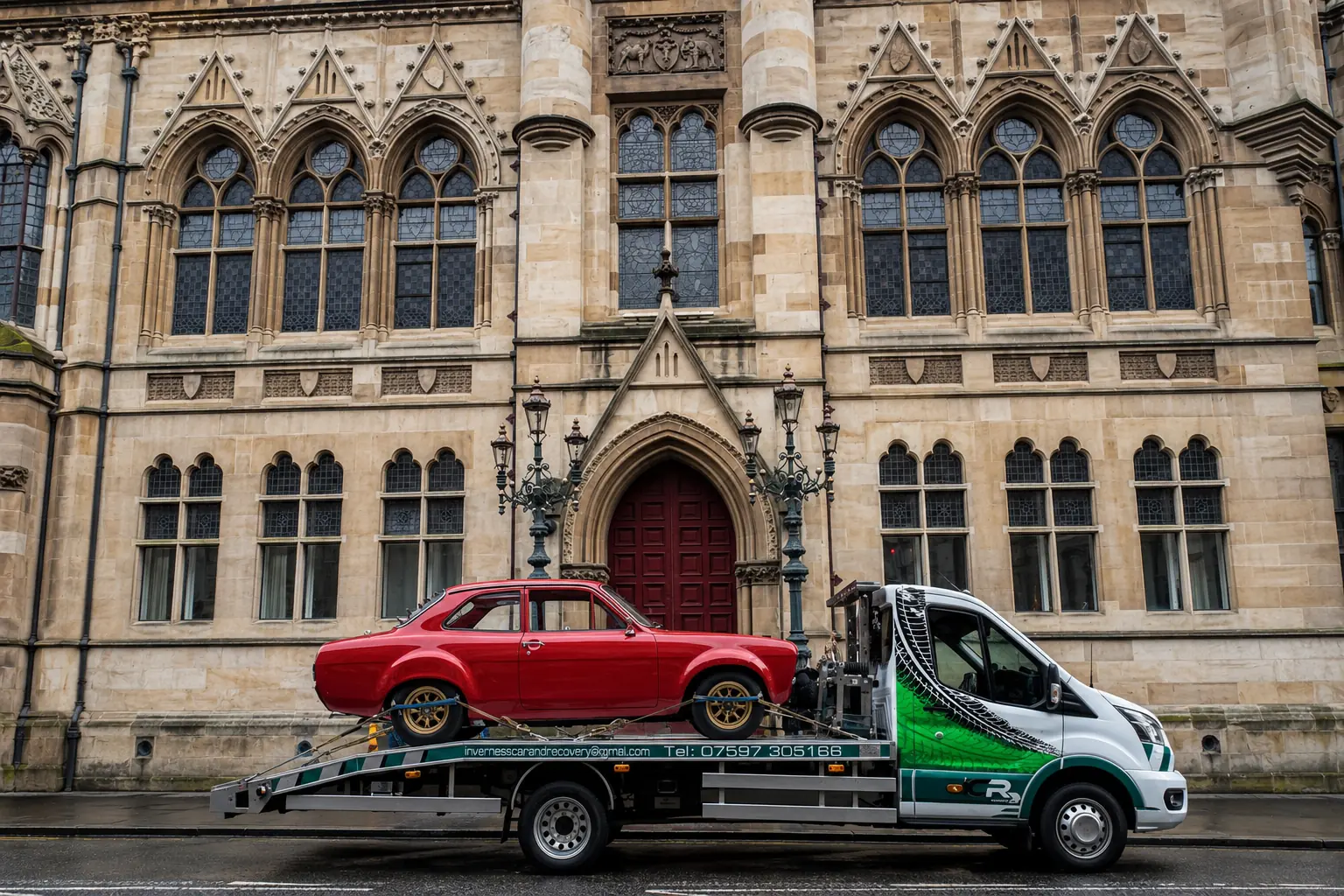 ICR recovery truck transporting a red classic Ford through Inverness